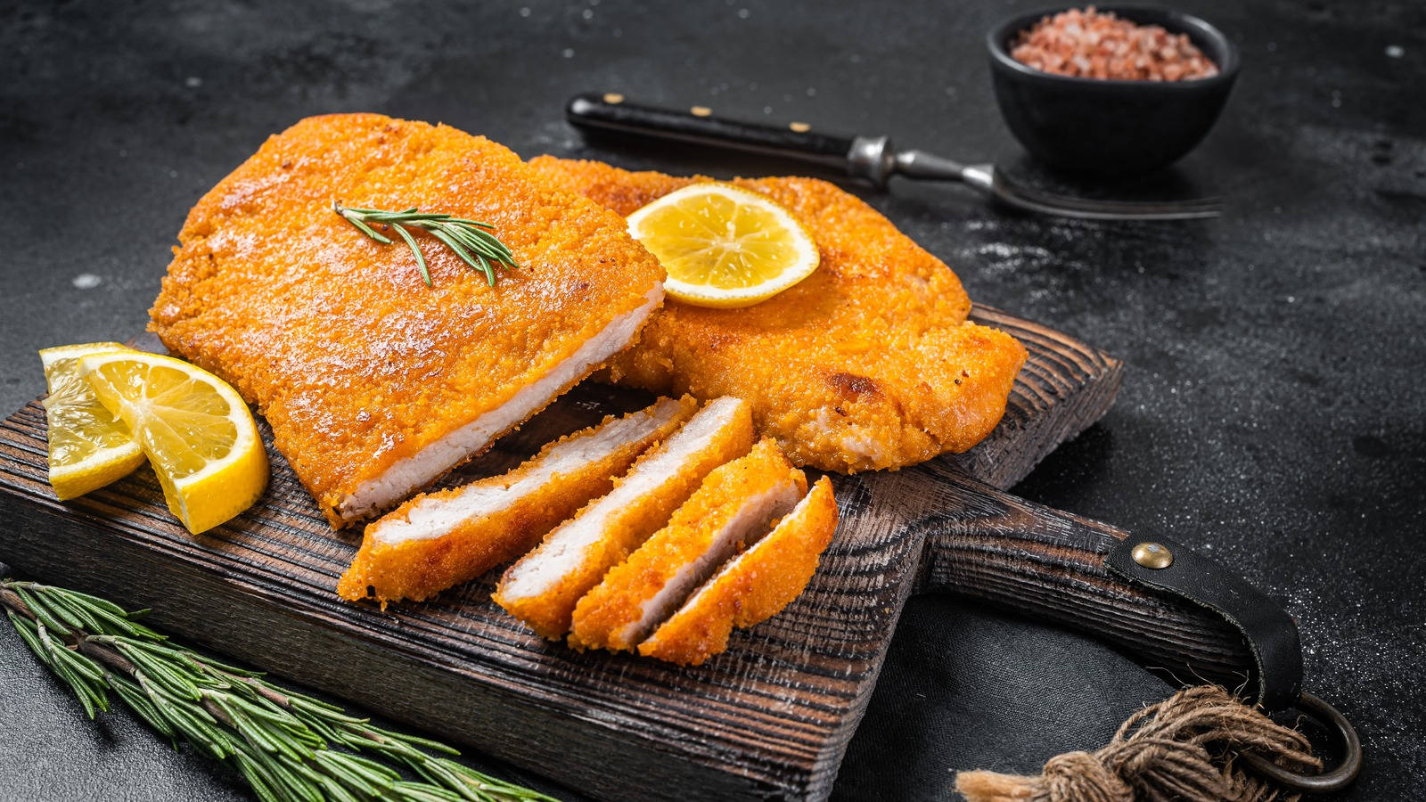 Scrumptious Wiener Schnitzel Served With Lemon Wedges And Parsley Garnish Wallpaper