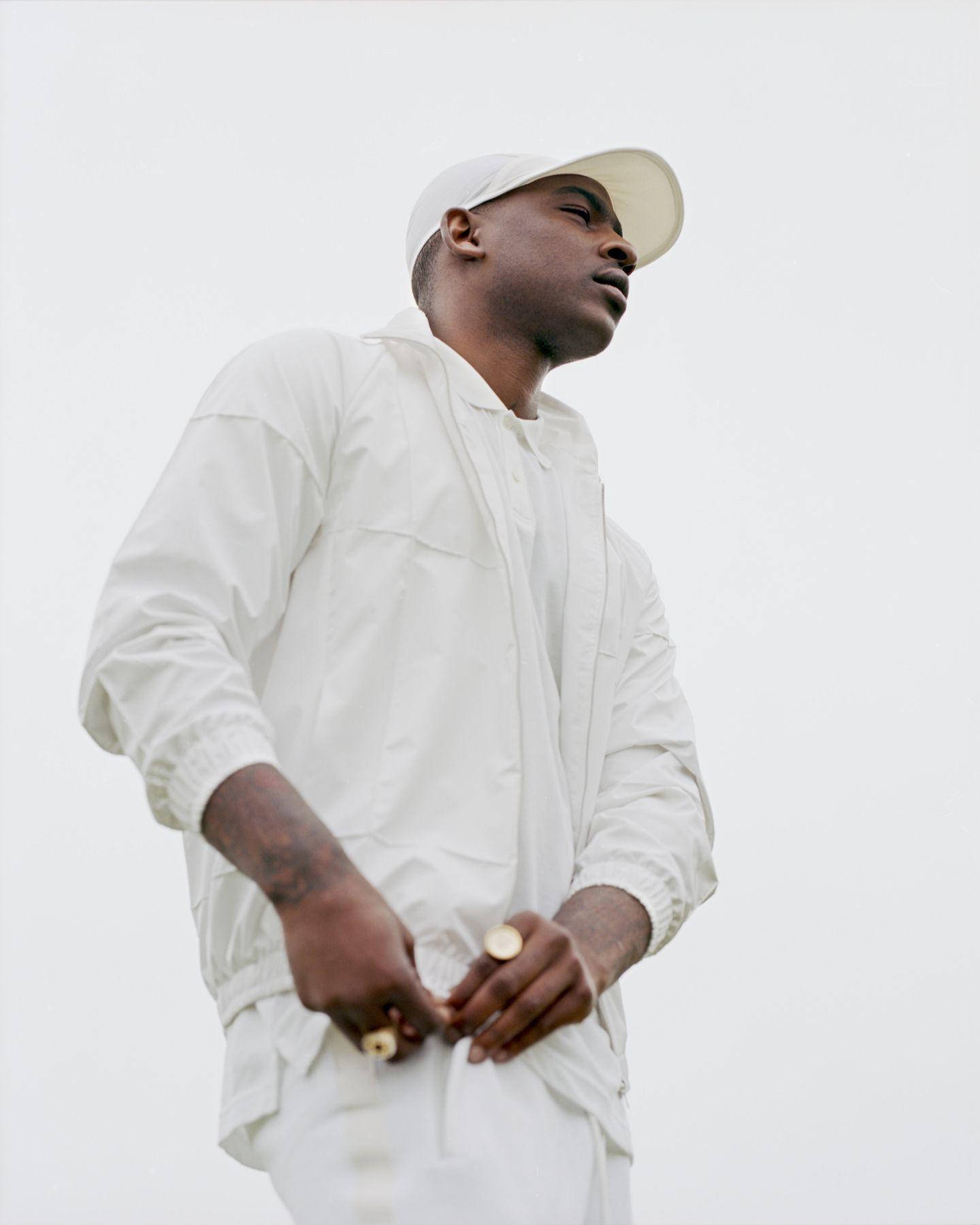 Skepta On Full White Outfit Wallpaper