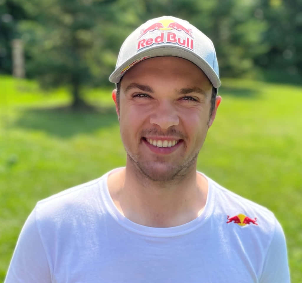 Smiling Man Red Bull Cap Outdoors Wallpaper