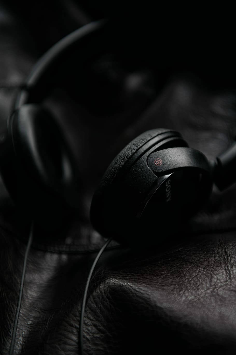 Sony Headphones On Black Leather Iphone Wallpaper