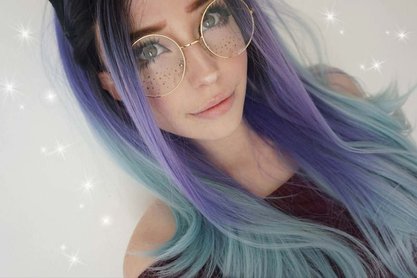 Starry Eyed Girlwith Purple Hairand Glasses Wallpaper