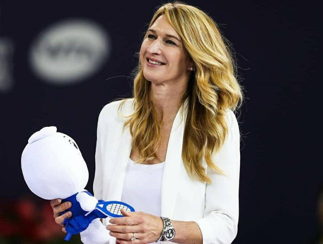 Steffi Graf Holding A Stuffed Toy Wallpaper