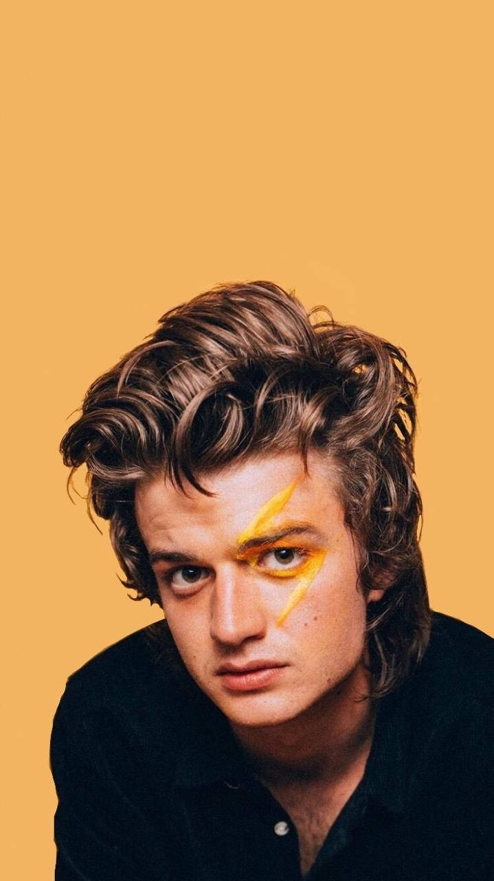 Stranger Things Cast Joe Keery Yellow Background Wallpaper