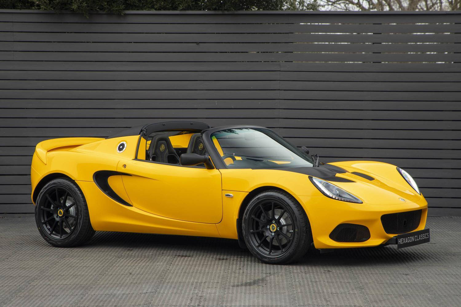 Stunning Yellow Lotus Sports Car In Garage Wallpaper