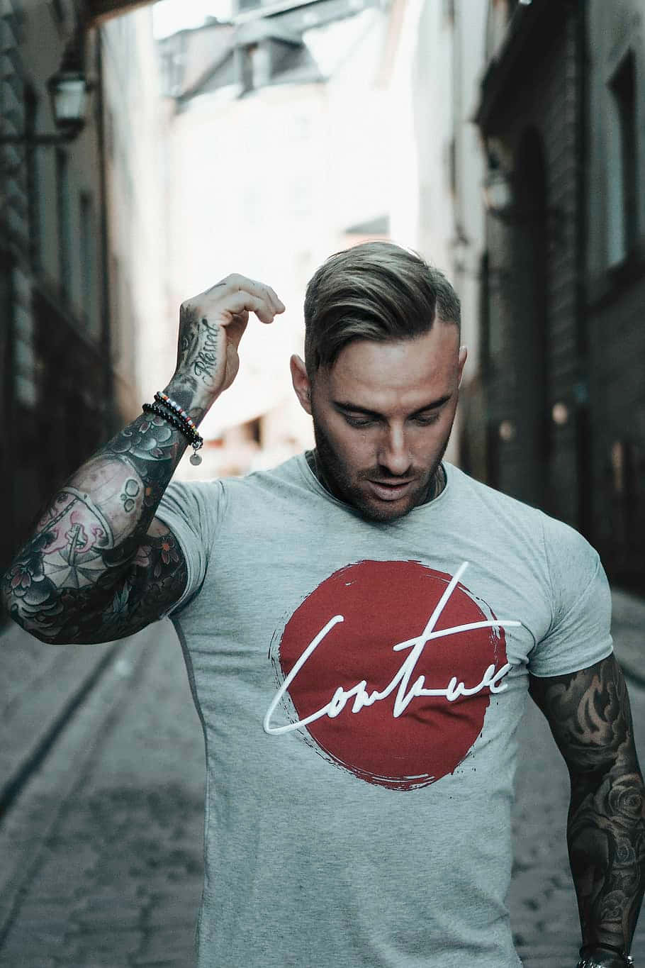 Stylish Individual Showcasing Arm Tattoos Wallpaper