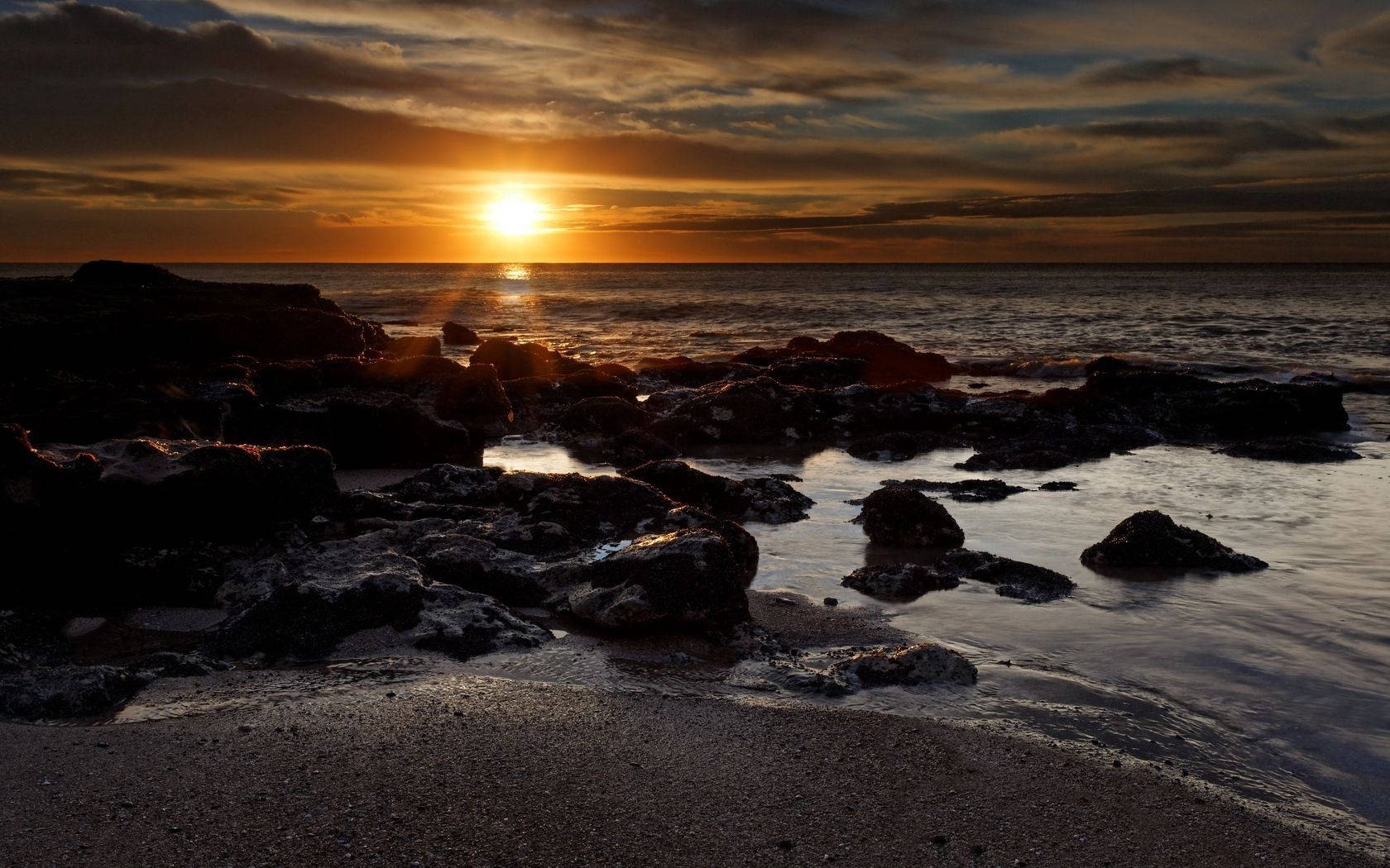 Sun Over Rocky Shore Wallpaper