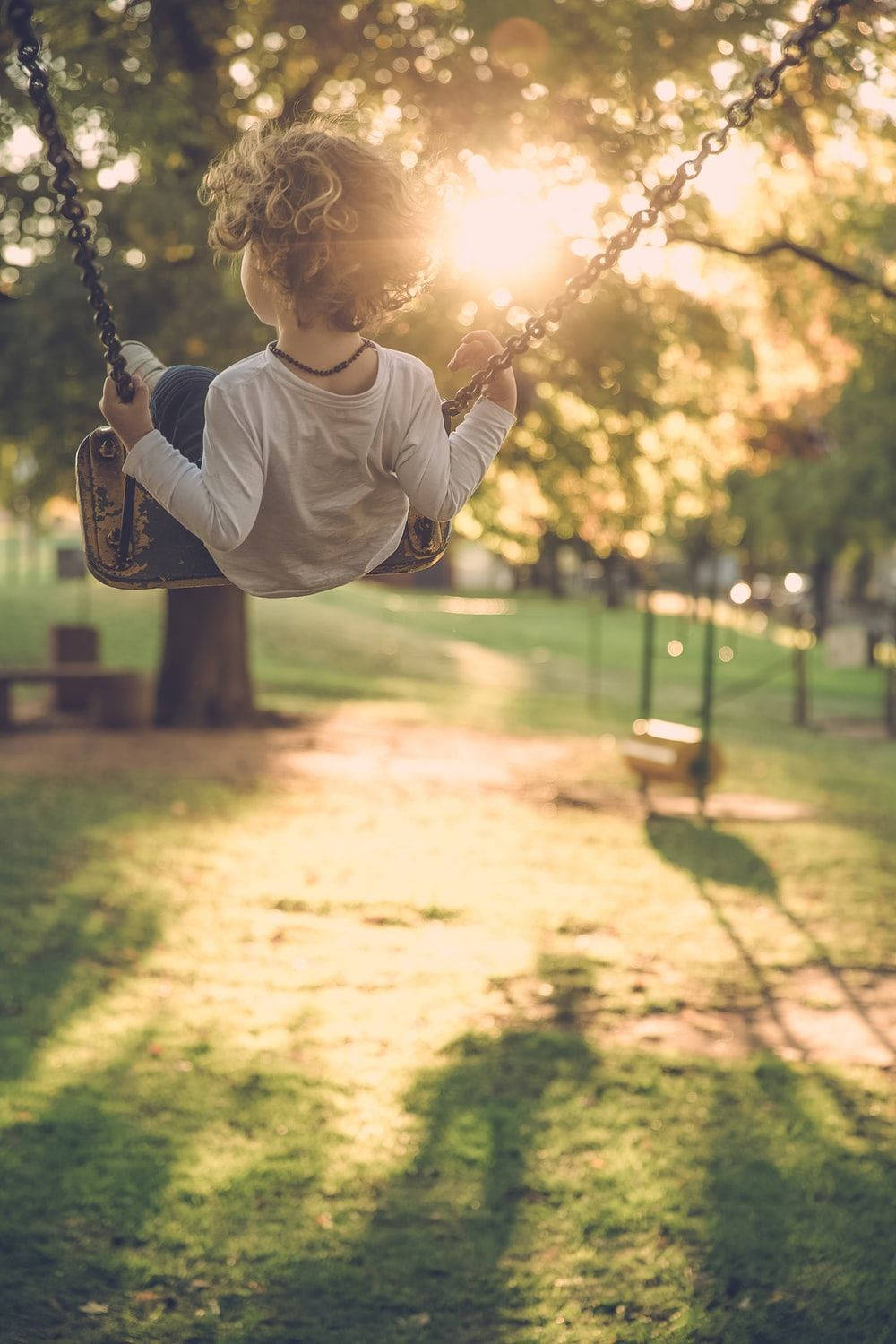 Sunlight On Playground Swing Wallpaper