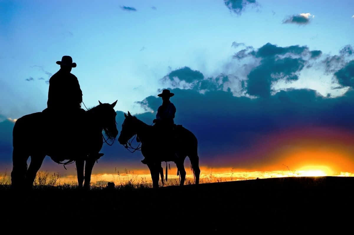 Sunset And Silhouettes Of Western Cowboys Desktop Wallpaper