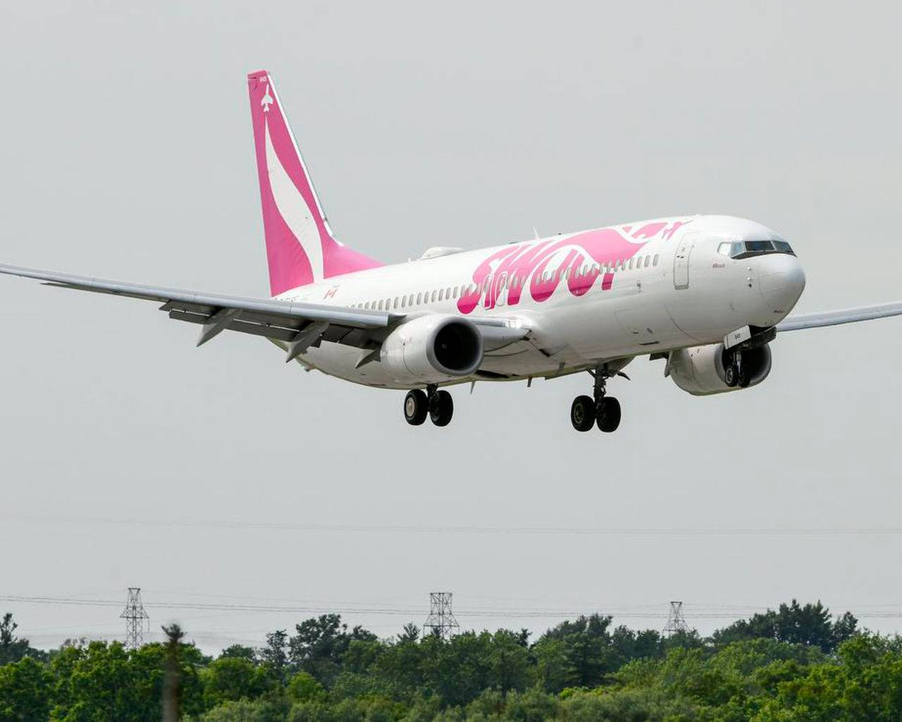 Swoop Airplane Touching Down On A Runway Wallpaper