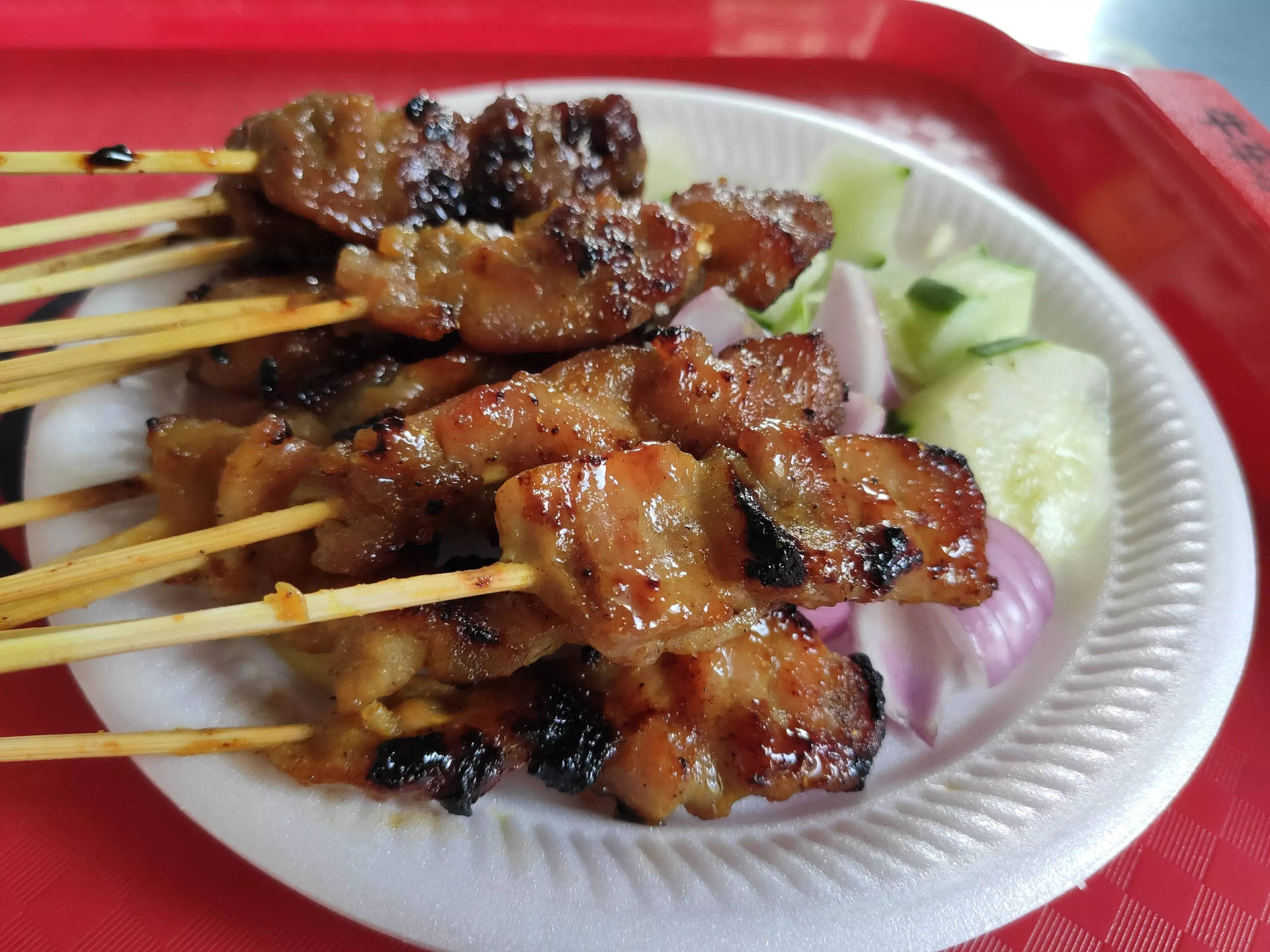 Tasty Satay Dish With Cucumber Salad Wallpaper