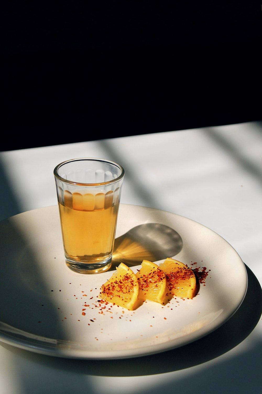 Tequila With Lemon Slices On Plate Wallpaper