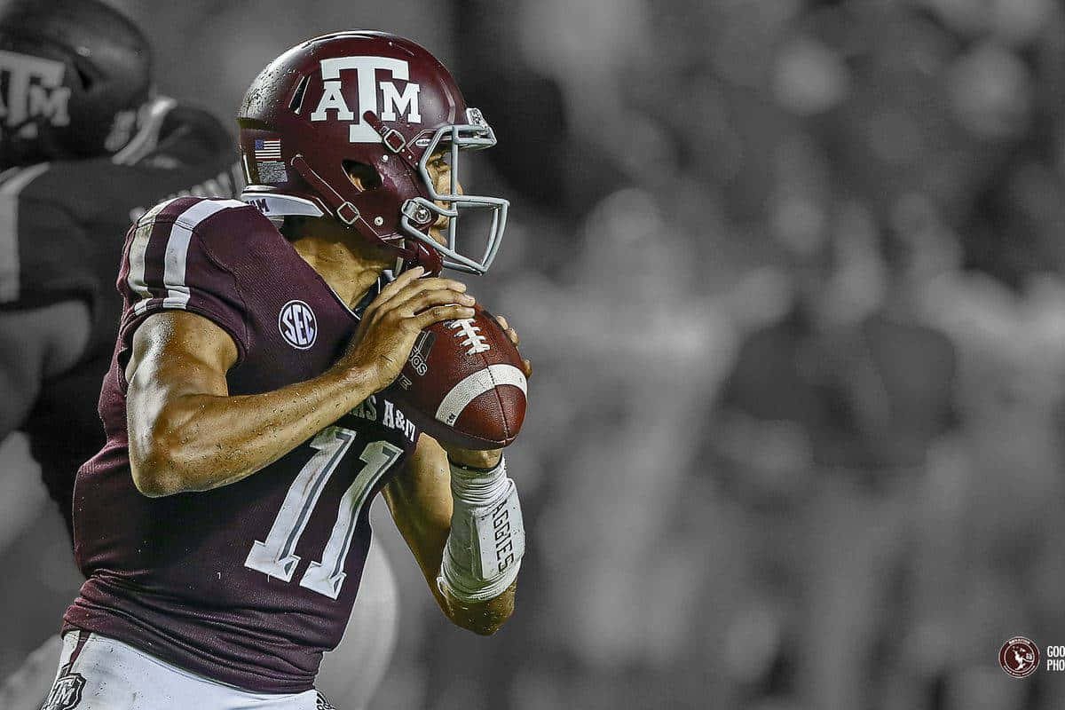 Texas Am Football Player Is Holding A Ball Wallpaper