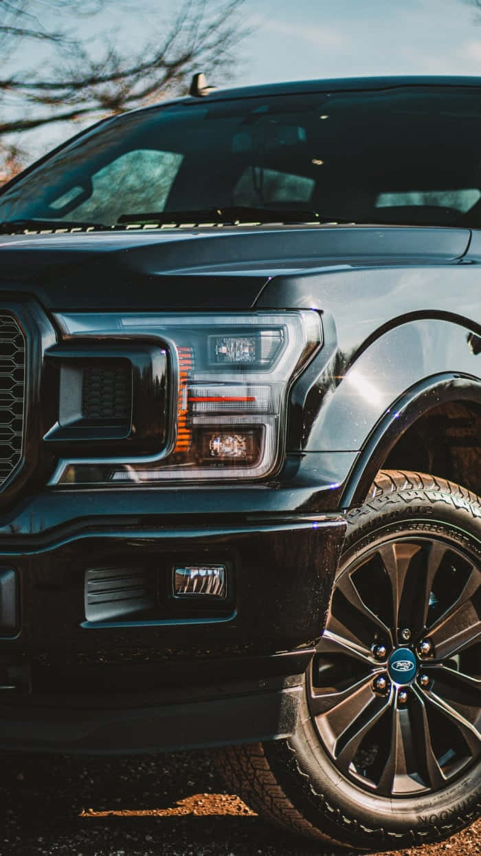 The Black 2019 Ford F - 150 Parked On A Dirt Road Wallpaper