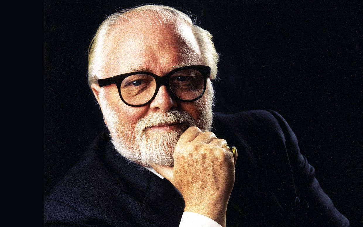 The Legendary Richard Attenborough Against A Black Backdrop Wallpaper