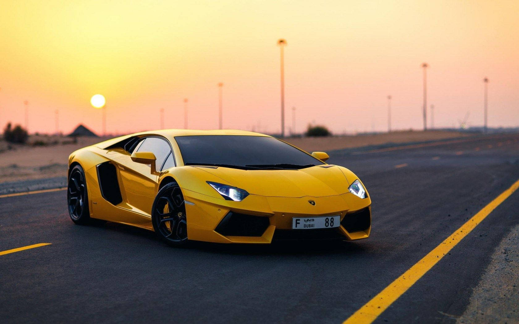 The Majestic Yellow Lamborghini Aventador At Sunset Wallpaper