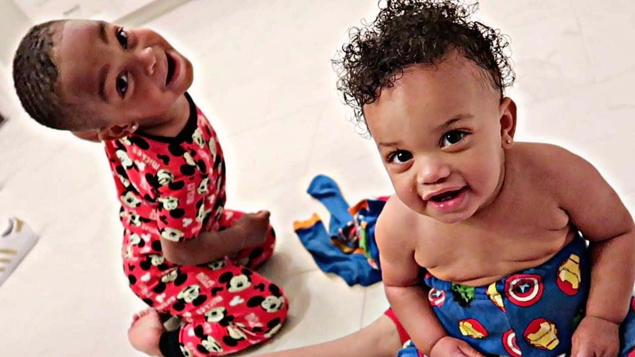 The Prince Family Radiating Joy And Love In A Playful Moment Wallpaper