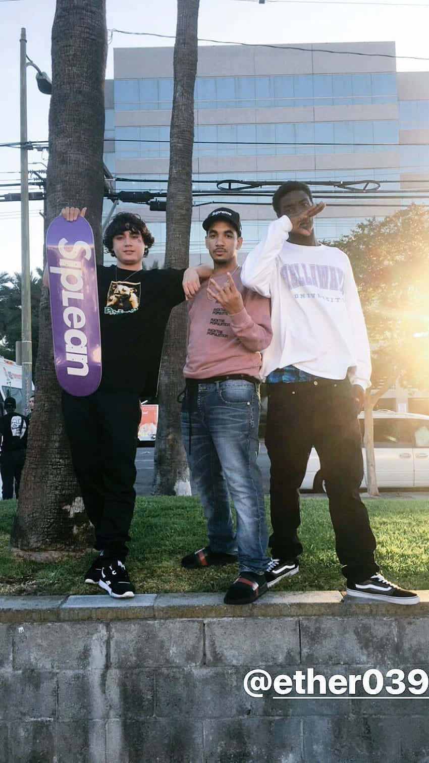 Three Men Standing Next To A Wall Wallpaper