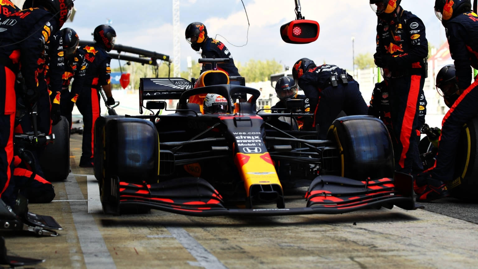 Thrilling Action At The Red Bull Racing Pit Stop Wallpaper