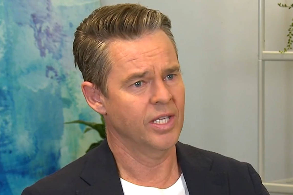 Todd Woodbridge Engaging In An Interview Wallpaper