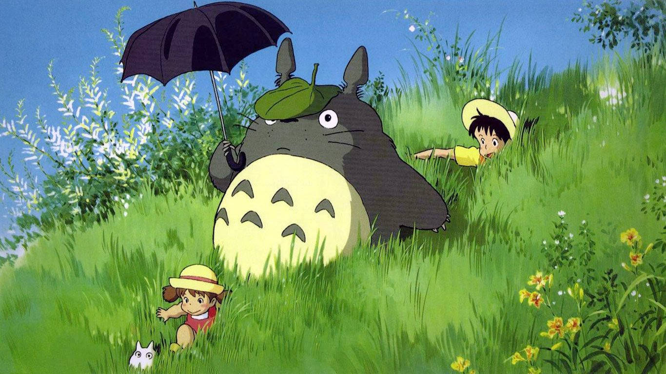 Totoro Joyfully Plays In A Field Of Grass Wallpaper