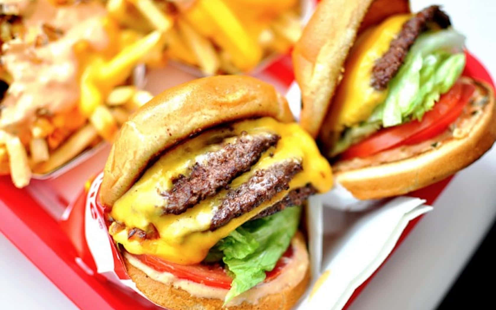 Two Hamburgers And Fries Are On A Red Tray Wallpaper