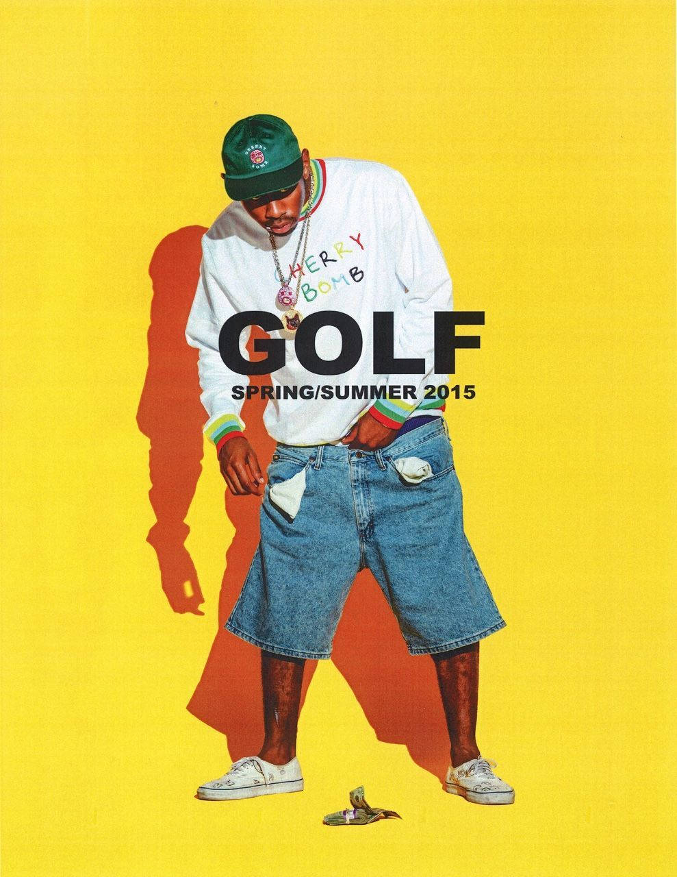 Tyler The Creator Sporting His Classic Yellow Golf Hat Wallpaper