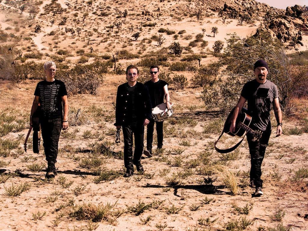 U2 Band Walkingin Desert Wallpaper