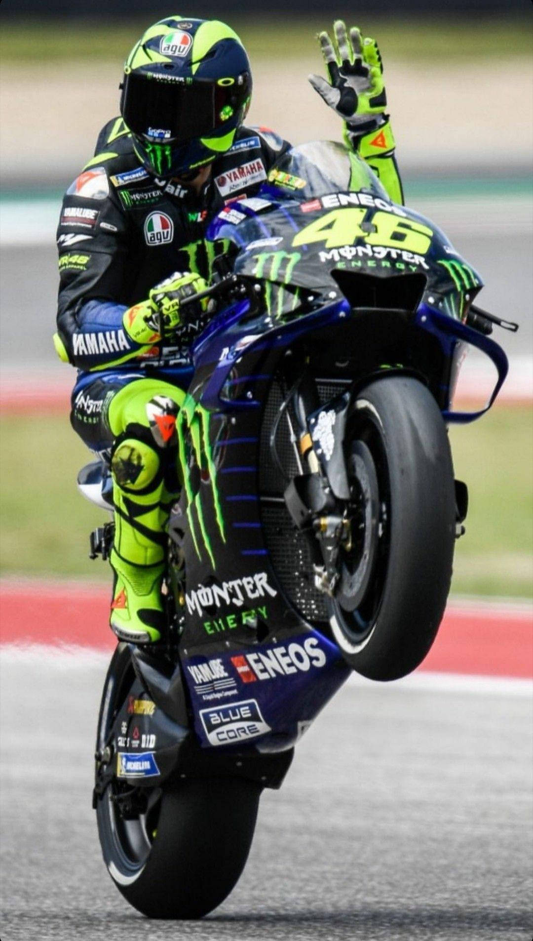 Valentino Rossi Perfecting A Signature Wheelie Stunt Wallpaper