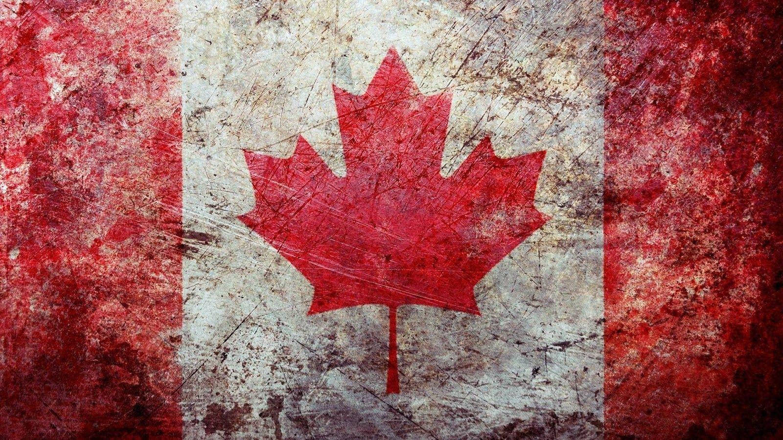 Vibrant And Proud Canadian Flag Waving In The Wind Wallpaper
