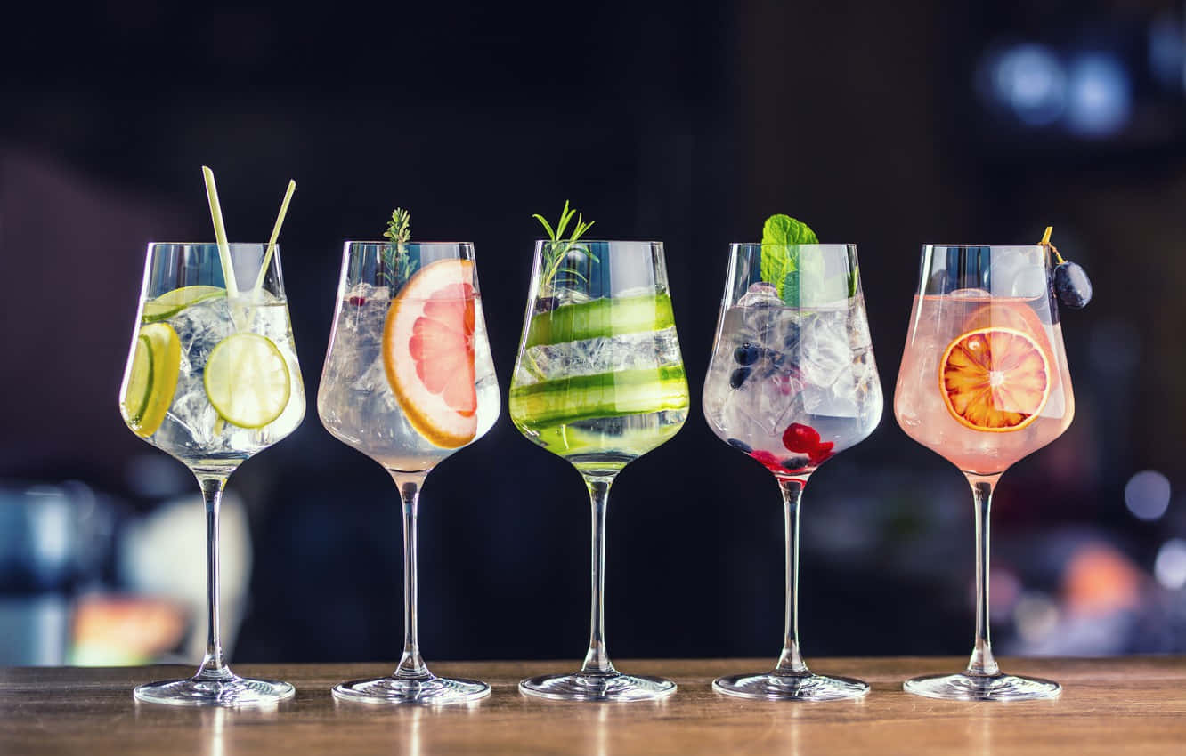 Wine Glasses With Fruit Cocktail Drinks On Bar Wallpaper