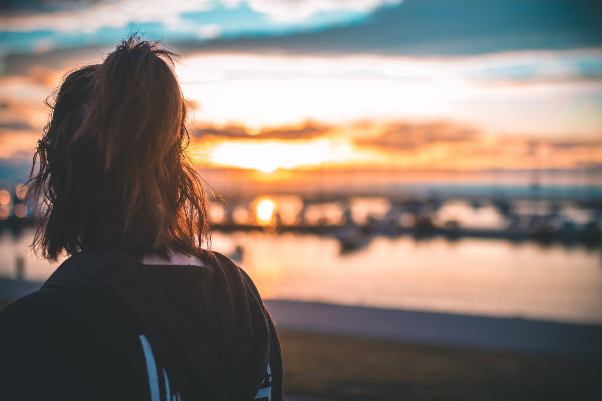 Woman Enjoying Serene Beach Sunset Wallpaper