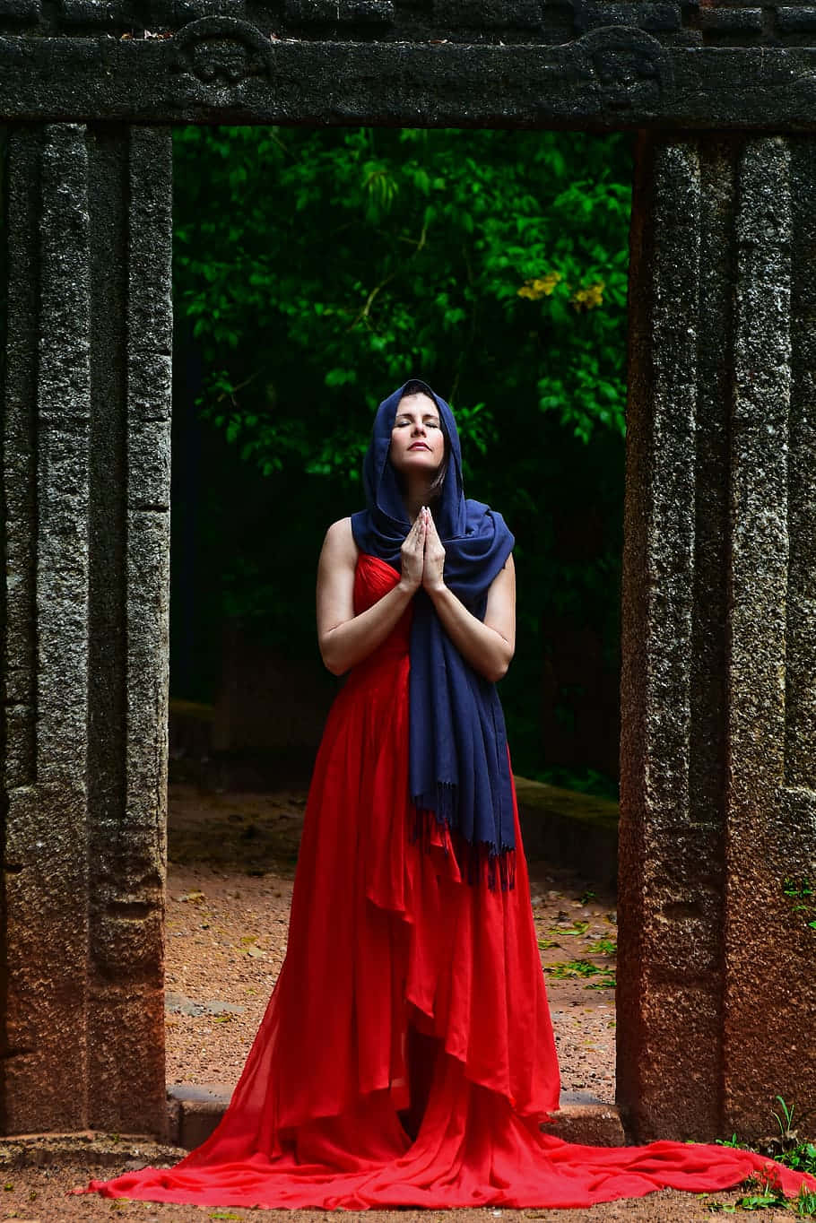 Woman Praying Under An Arch Wallpaper