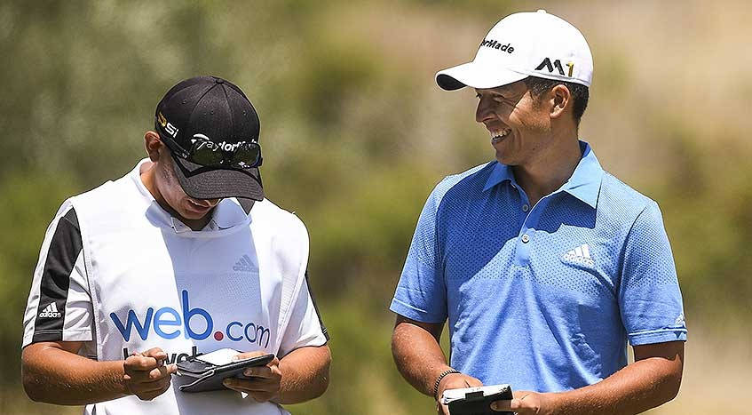 Xander Schauffele Evaluating The Next Move On The Golf Course With A Colleague Wallpaper