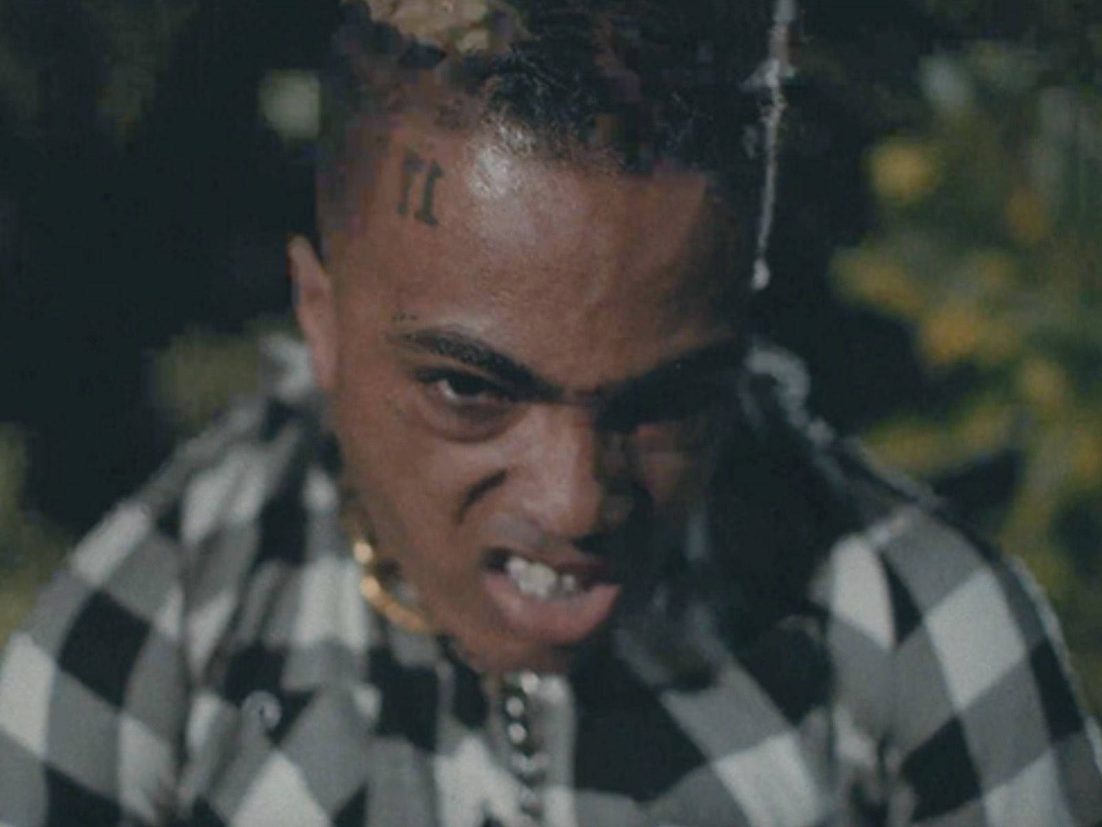 Xxxtentacion Performing To An Angry Crowd Wallpaper