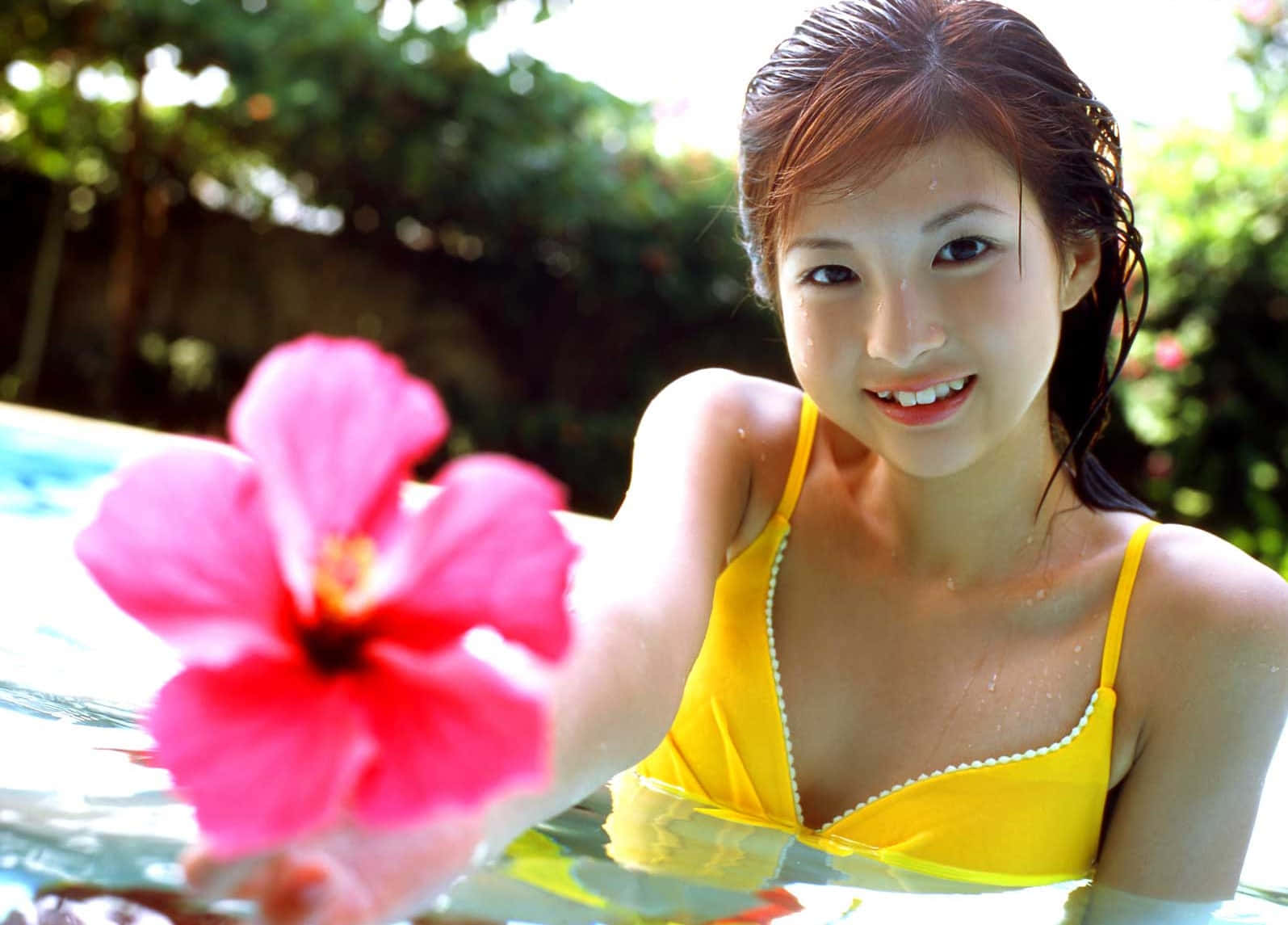 Young Female Model Holding Flower Wallpaper