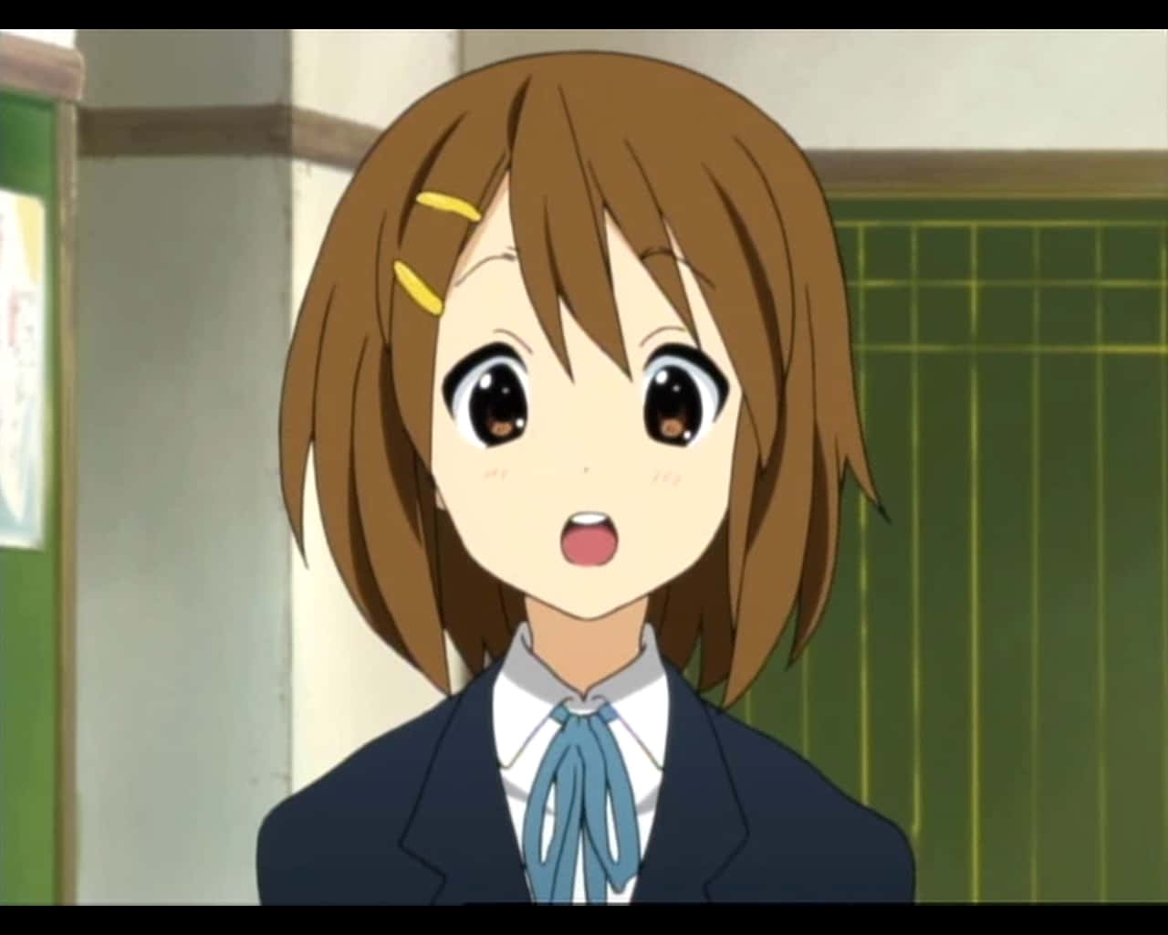 Yui Hirasawa Playing Her Guitar Confidently Wallpaper