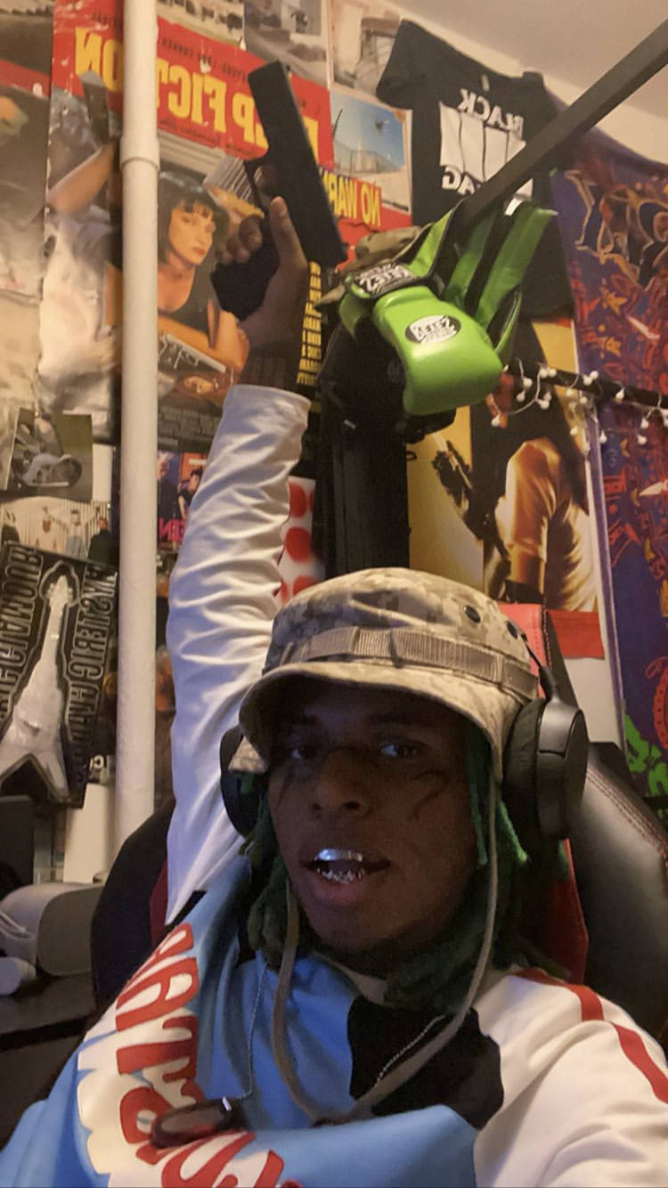 Zillakami Pointing A Gun Above Wallpaper