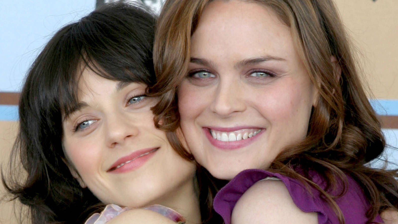 Zooey Deschanel And Emily Deschanel Hugging Wallpaper