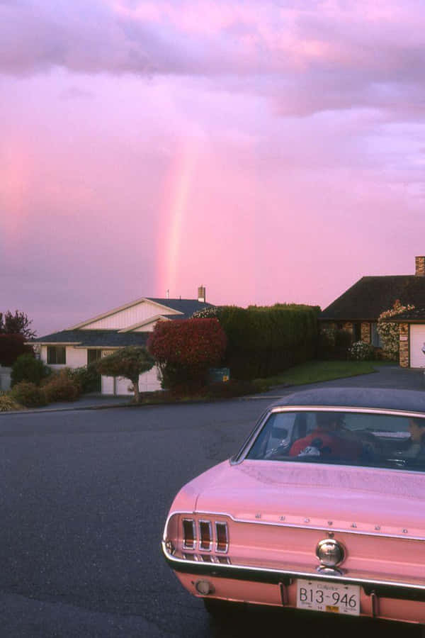 A Beautiful Streamlined Vintage Car In A Striking Pink Colour Wallpaper