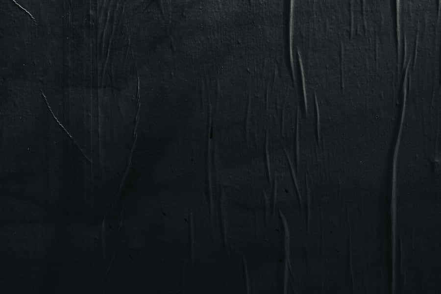 A Black Wall With A Black Paint Wallpaper