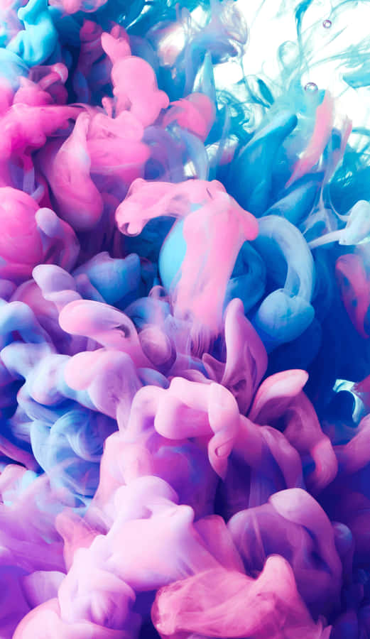 A Blue And Pink Liquid Is Floating In The Air Wallpaper