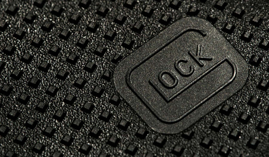 A Close Up Of A Black Leather Bag With A Logo On It Wallpaper
