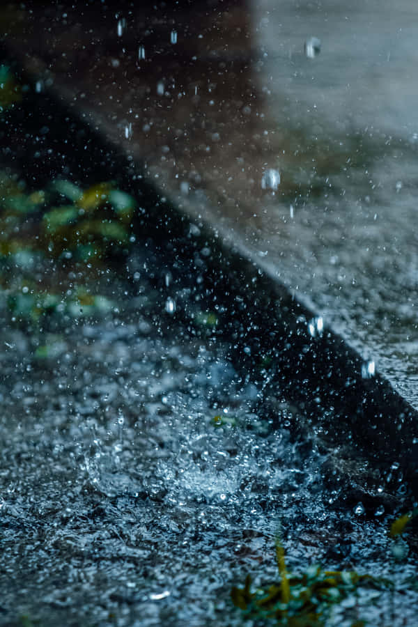 A Close Up Of A Rain Drop On A Sidewalk Wallpaper