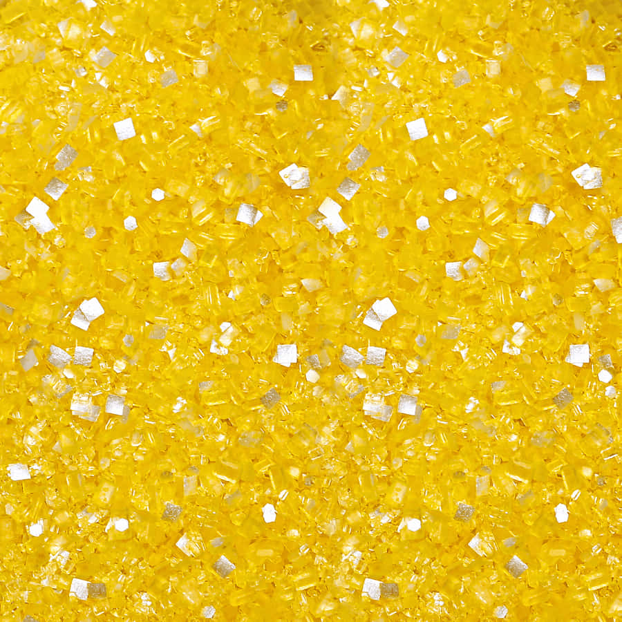 A Close Up Of A Yellow And Silver Glitter Wallpaper