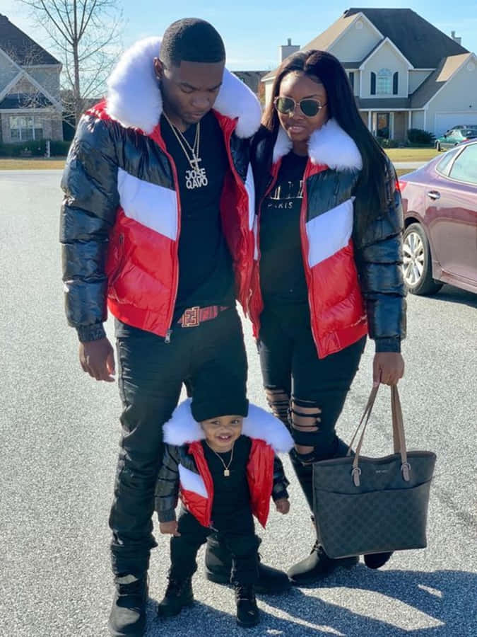 A Family In A Red, White And Black Jacket Wallpaper