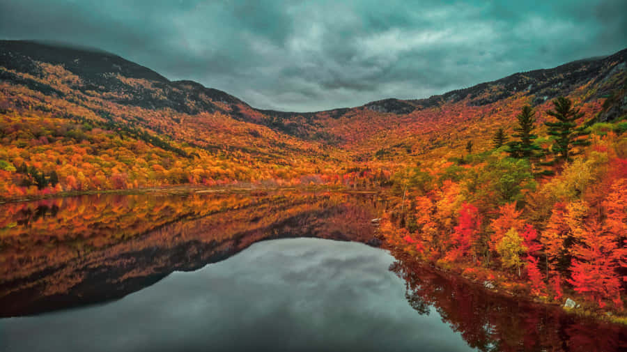 A Lake Surrounded By Colorful Autumn Trees Wallpaper