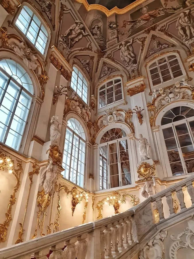 A Large Building With Ornate Staircases And Windows Wallpaper