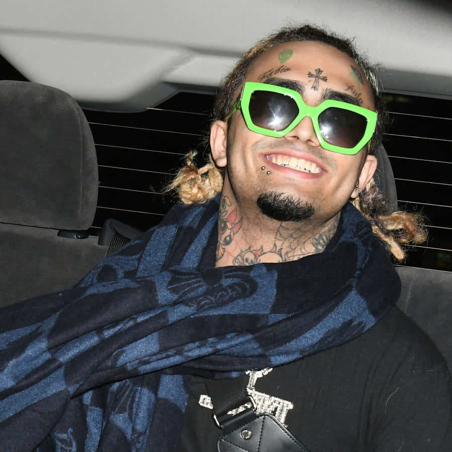 A Man In A Car With Sunglasses And A Scarf Wallpaper