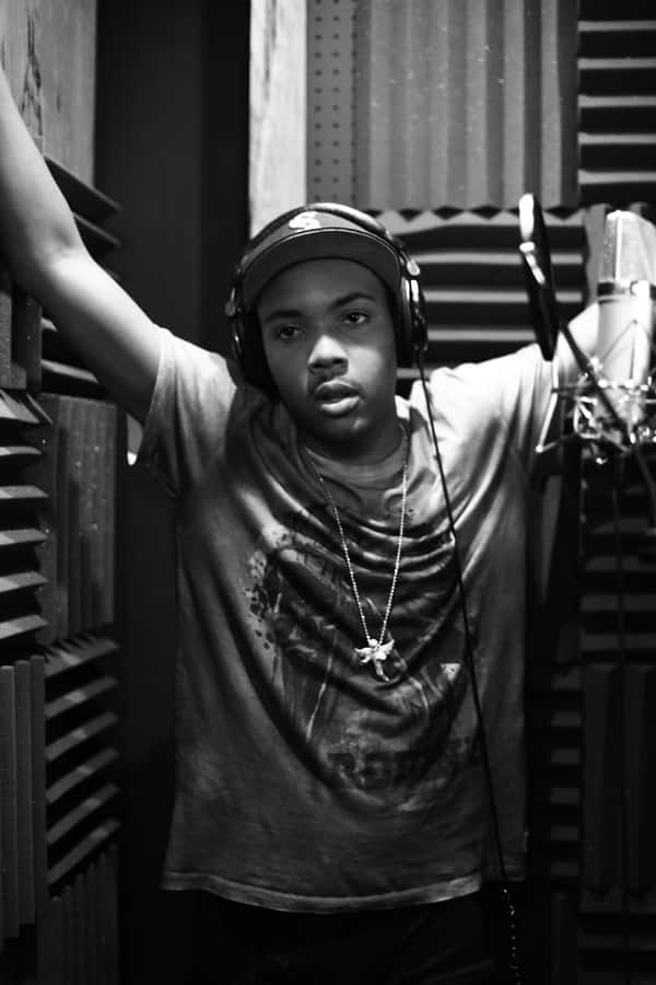 A Man In A Recording Studio With Headphones On Wallpaper