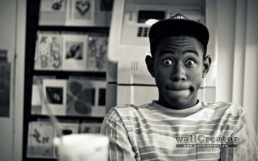 A Man Is Sitting In Front Of A Refrigerator Wallpaper